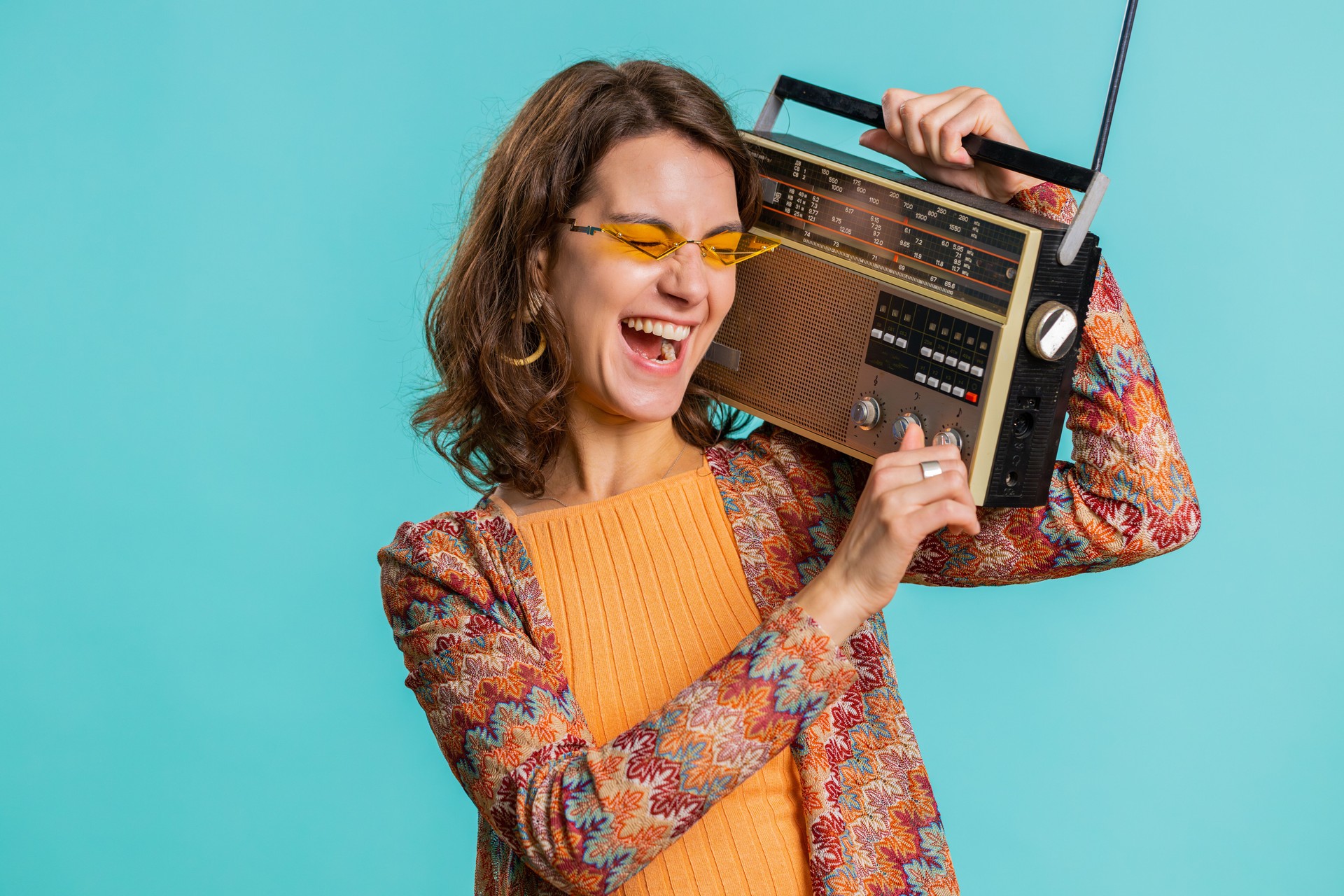 Woman using retro tape record player to listen music disco dancing of favorite track having fun